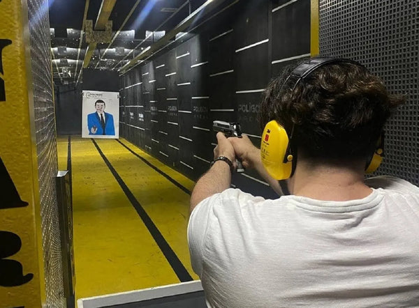 Boy shooting a gun in a shooting range