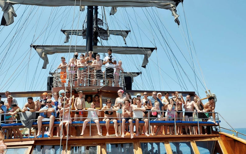 People sitting on the deck of Catamaran Boat