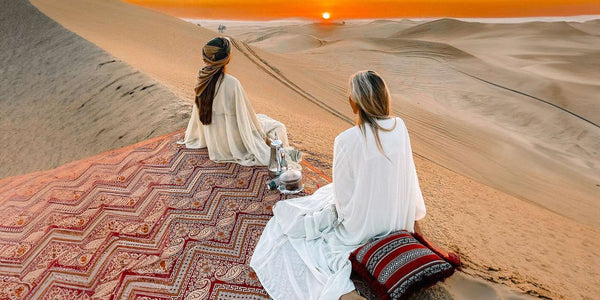 Girls sitting in desert