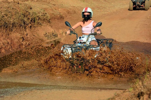 Girl riding ATV Quad in mud