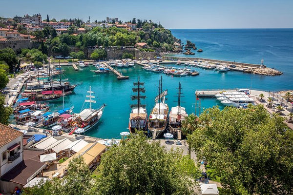 Harbor with boats and a coastal town on a sunny day