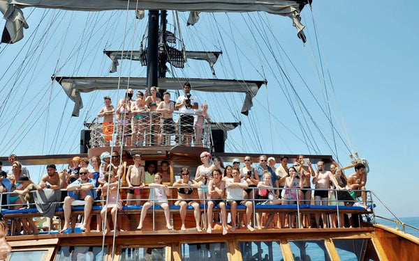 People sitting on the deck of Catamaran Boat