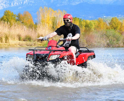 Boy riding ATV Quad in water