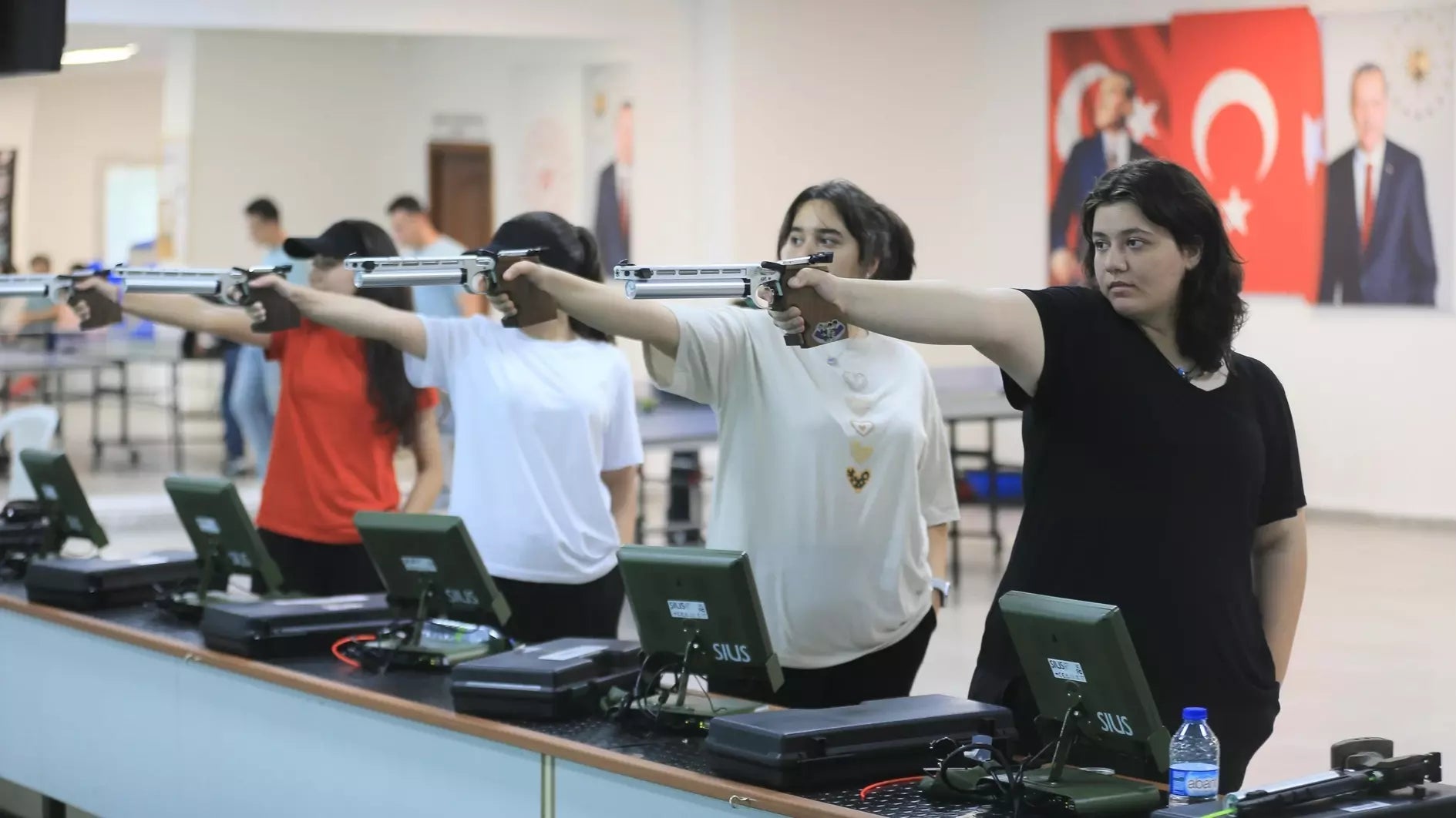 girls practicing to shoot guns
