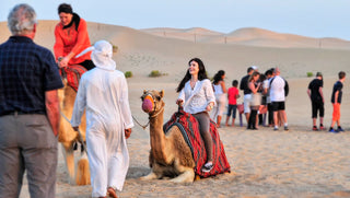 People camel trekking through the desert