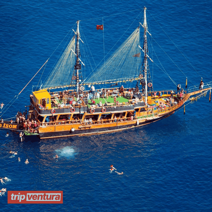 Tourists relaxing and enjoying the scenic views on the deck of the pirate boat