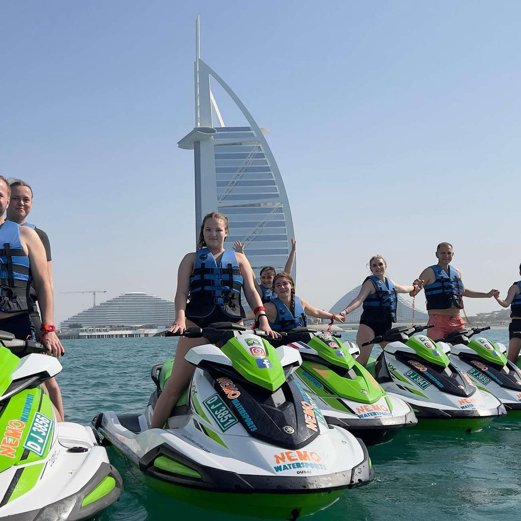 People participating in a jet ski tour in Dubai, with the iconic Burj Al Arab hotel