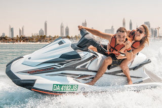 Couple riding jet ski