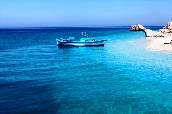 Suluada’s rugged rocky coastline surrounded by crystal-clear waters, showcasing the island’s natural beauty