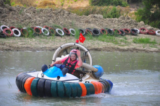 Girl driving hovercraft in the water
