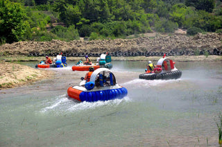 People driving hovercraft in the water