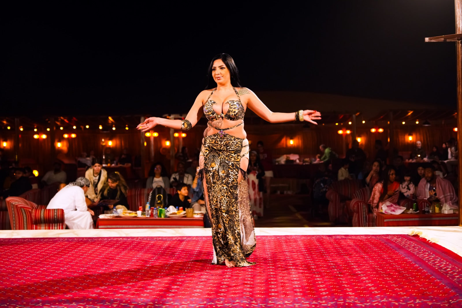 Belly dancer captivating the audience during an evening show at the camp.