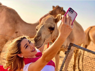Girl taking selfie with camel