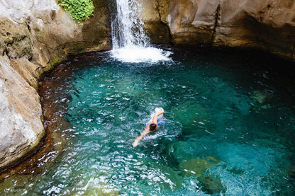 Man swimming in Sapadere Canyon Waterfall 
