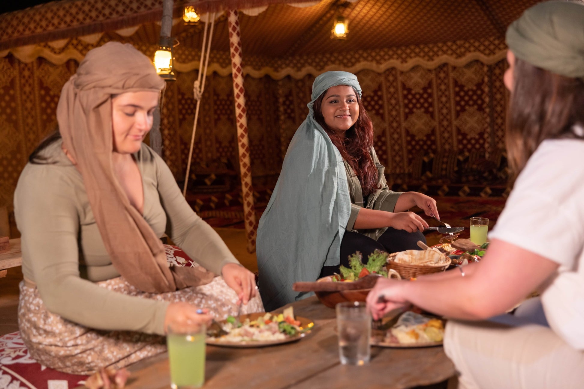 Guests seated at a communal table enjoying a traditional dining experience.