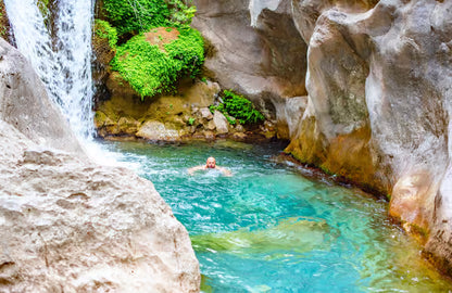 Man swimming in Sapadere Canyon Waterfall 
