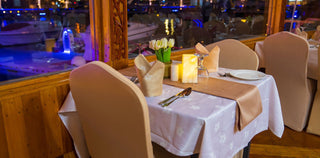 Depicts a dinner setting on a traditional dhow boat