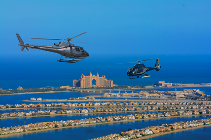 Two helicopters flying at the Palm
