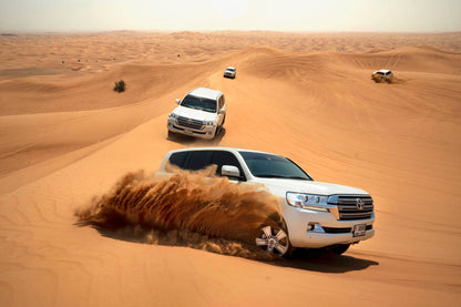 4x4 vehicle navigating through the red dunes during an exclusive desert safari.