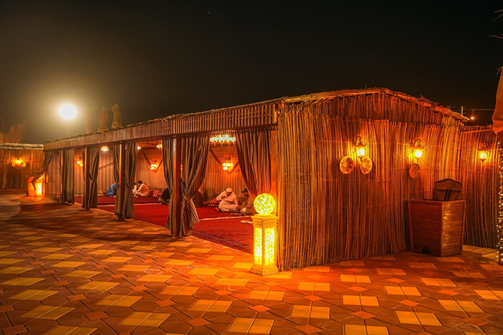 Premium Bedouin-style camp setup with luxurious seating in the Dubai desert.