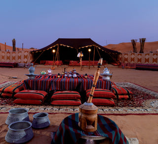 traditional Bedouin-style tent setup in a desert environment