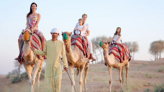 Camel riding experience, likely as part of a desert safari