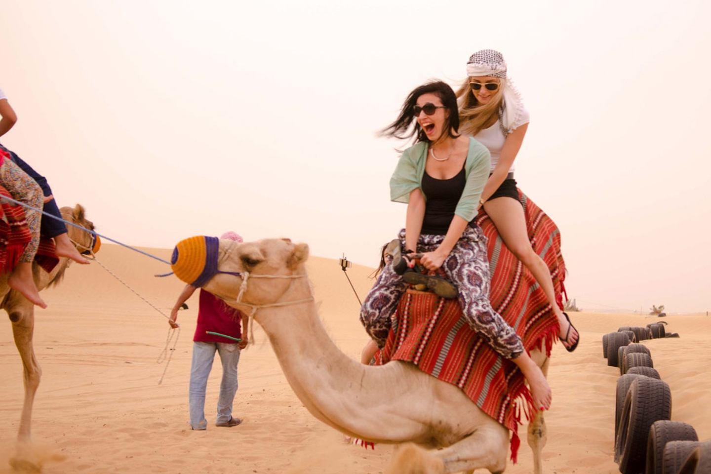 Girls Riding Camels in Desert, Dubai