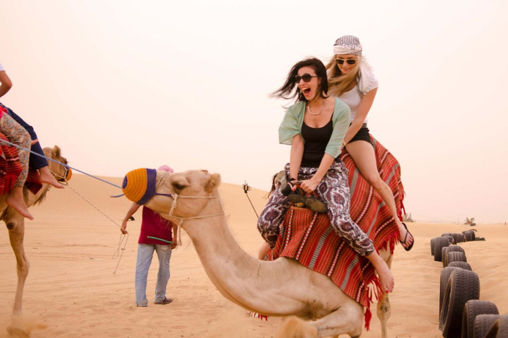 Girls Riding Camels in Desert, Dubai