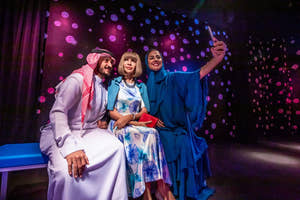 isitors interacting with wax figures at Madame Tussauds Dubai,